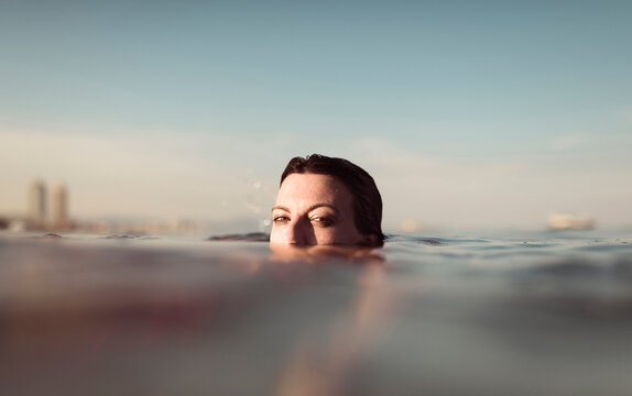 Girl face at sea surface looking at camera