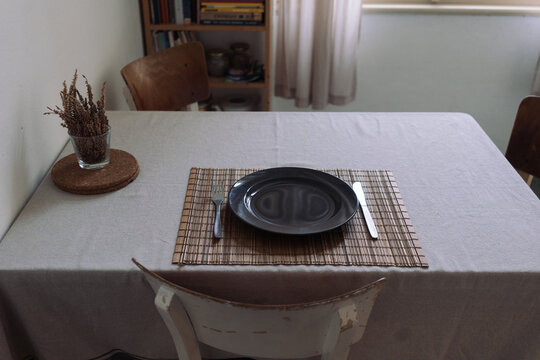 Dining table furnished with cutlery for one person