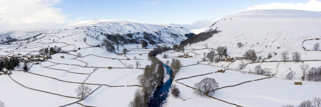 Swaledale river covered in snow in winter aerial North Yorkshire Dales