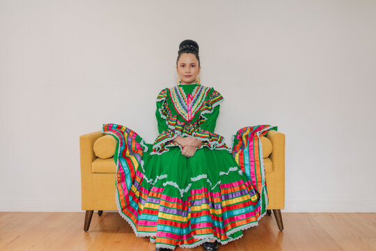 Portrait of a Mexican-American tween girl dressed up with a Jalisco folkloric dress