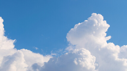 Naklejka na ściany i meble Fluffy white clouds on a blue sky