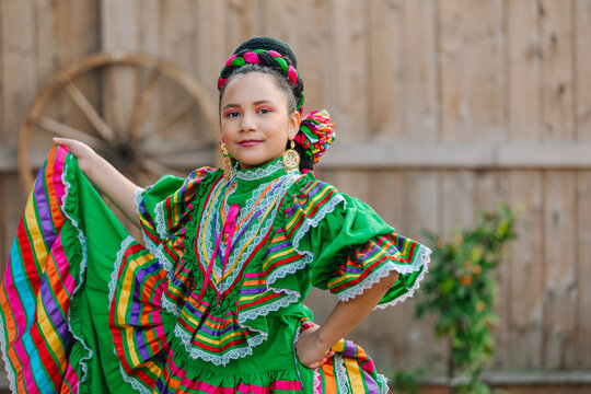 Portrait of a Mexican-American tween wearing a traditional Mexican dress