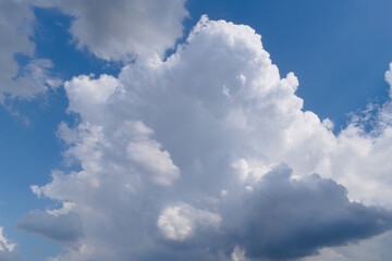 Naklejka na ściany i meble Fluffy white clouds on a blue sky