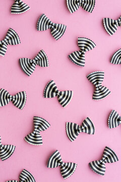 Black And White Striped Pasta Bow Background On Pink