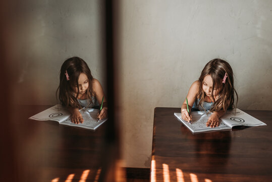 Preschool age child distance learning at home with reflection