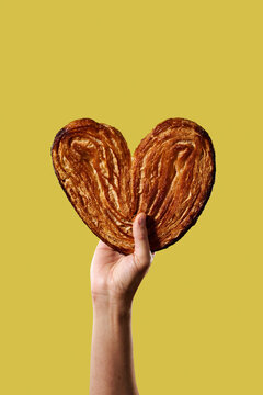 man with a puffy pastry heart in his hand