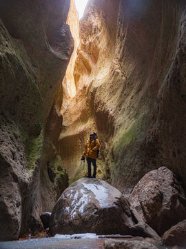 Traveler inside a massive mountain gorge
