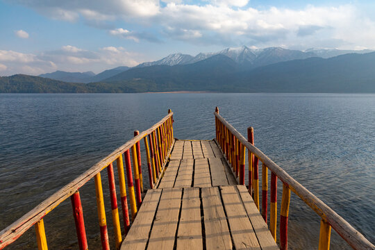 A wooden deck on a lake.