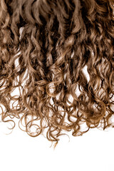 Brunette curly hair extension isolated on white background