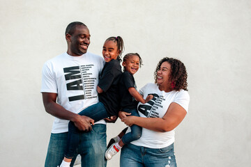 Happy Black parents with two daughters
