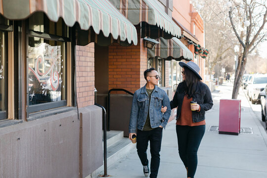 Couple Walking in City with Coffee