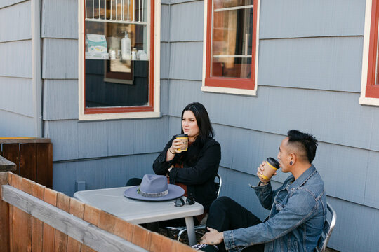 Couple Sitting on Patio Drinking Coffee