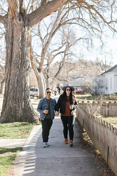 A Smiling Couple Walking in Neighborhood