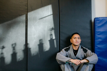 Martial Arts Fighter Sitting in Gym