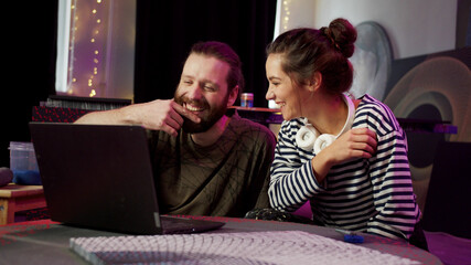 Two painters are searching something on the Internet 