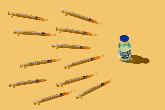 syringes and mock bottle of covid-19