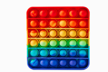 Square shape anti-stress pop it toy. Rainbow touch fidget isolated on white background. New fashionable silicone toy.