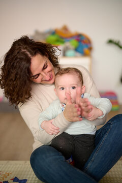 Mother playing with adorable toddle son