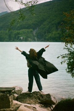 A woman by the lake in the mountains