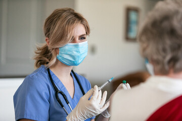 Health: Nurse Prepares Vaccination Of Senior In Her Home