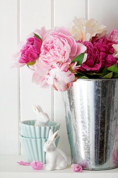 Fowers on shelf with easter objects