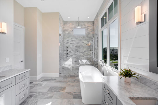 Modern Master Bathroom in High End Home in Florida with a Large Tub and Window