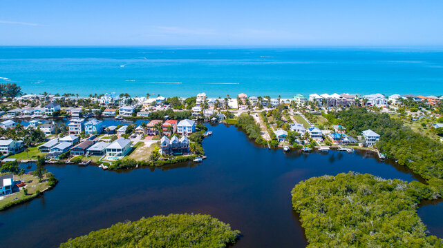 Aerial drone photo in Florida with the beach in the background and bay waters with mangroves in the foreground