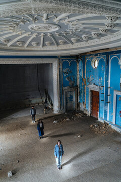 three friends in an abandoned cinema building