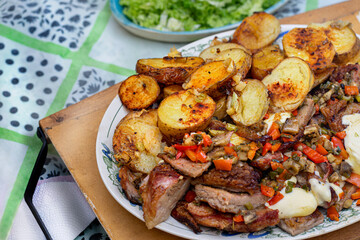 Oven roasted meat and potatoes with vegetables