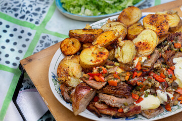 Oven roasted meat and potatoes with vegetables