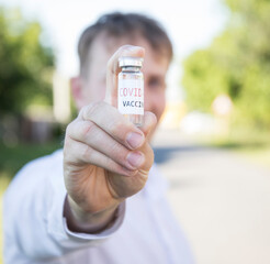 Man hand holding vaccine bottle. Vaccine. Bottle. Hope. 