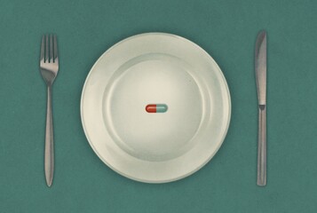 pill on plate with knife and fork
