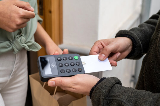 Delivery man receiving payment with credit card