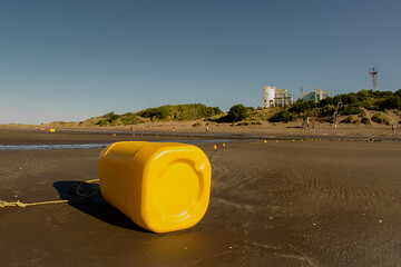 yellow plastic buoy for fishing on the beach