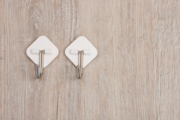 Two plastic adhesive utility wall fixed hooks with metal hooks for hanging clothes