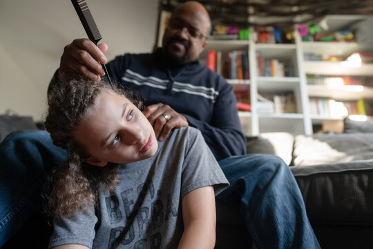 Low Angle Of Boy Getting Braids Removed