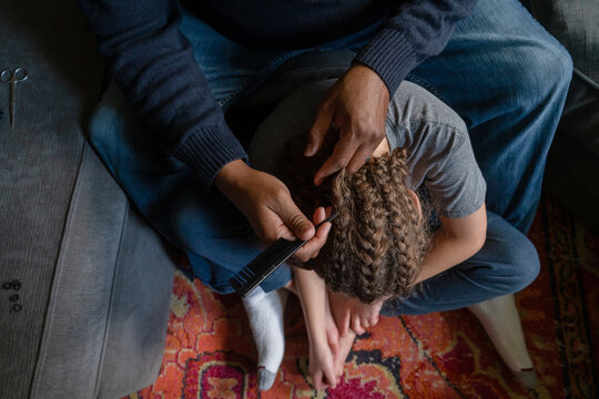Man removes braids of child