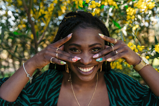 Happy black woman with cool manicure