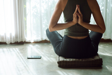 Stylish girl meditates near the window  