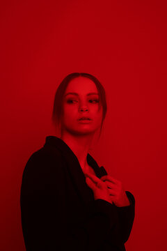 Portrait of a young blond girl in a suit 