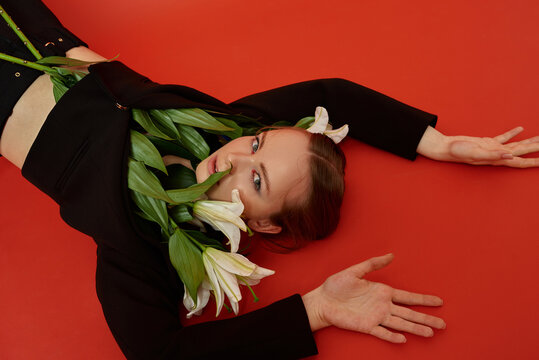 Portrait of a young blond girl with lilies