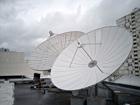 pair of large parabolas for satellite reception located on a roof
