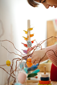 Woman decorating branches for Easter