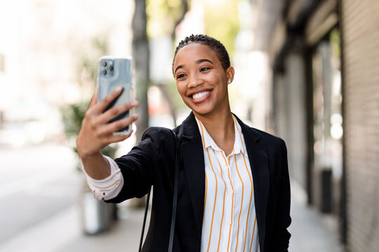 Successful Woman Takes a Selfie on an Empty City Street