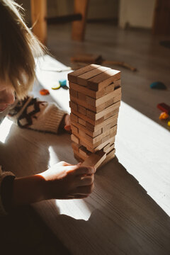 A Toddler Playing A Wooden Blocks Floor Game