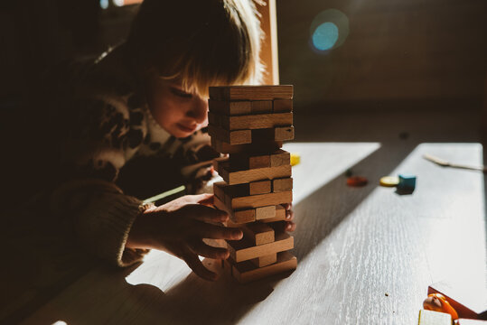 A Toddler Playing A Wooden Blocks Floor Game