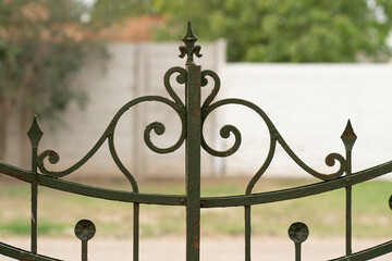 Fototapeta na wymiar top of a very old ornate iron door