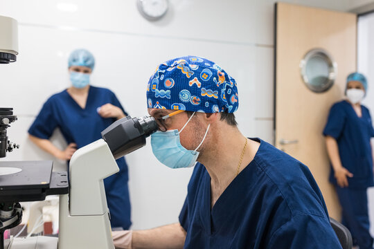 Embryologist working with microscope in laboratory