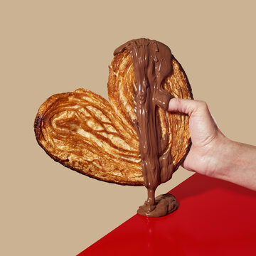 man with a heart-shaped pastry in his hand
