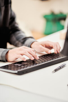 Crop man using computer in home office